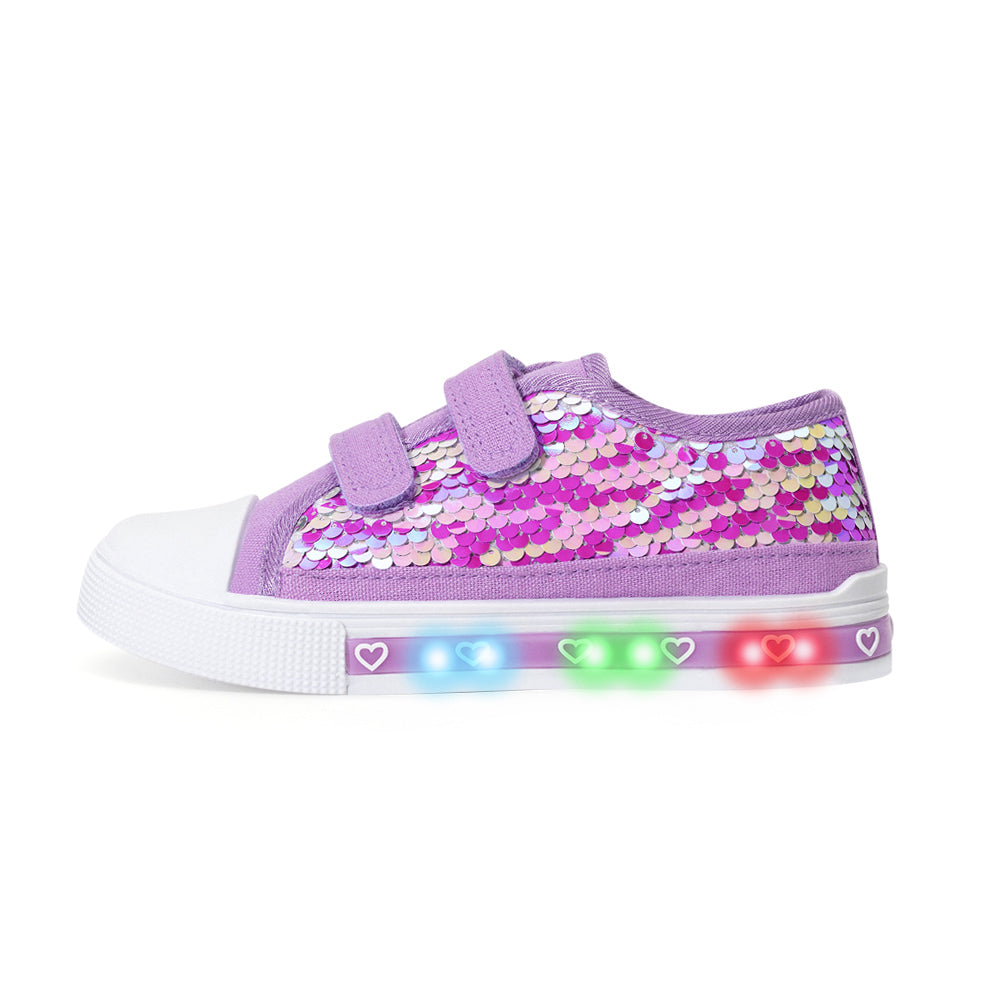 Purple sequin shoe with LED lights on a white background