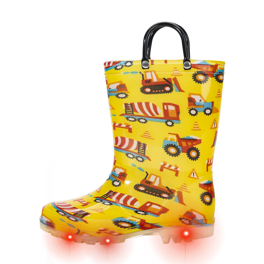 Yellow rain boot with construction vehicle pattern and light-up sole on a white background
