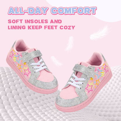 Pink and silver children's shoes with star designs on a pink background